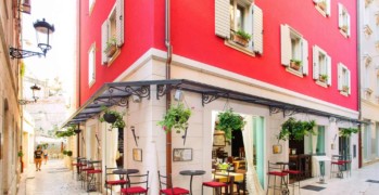 Marmont Heritage hotel in the city center in Split, luxury red hotel on the corner with tall bar stools and flowers